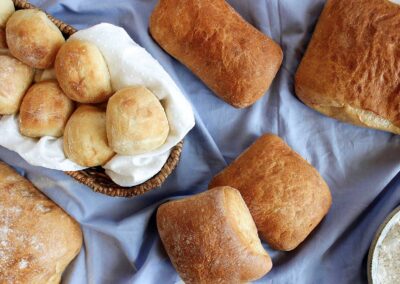 Fresh bread and rolls on a blue tablecloth