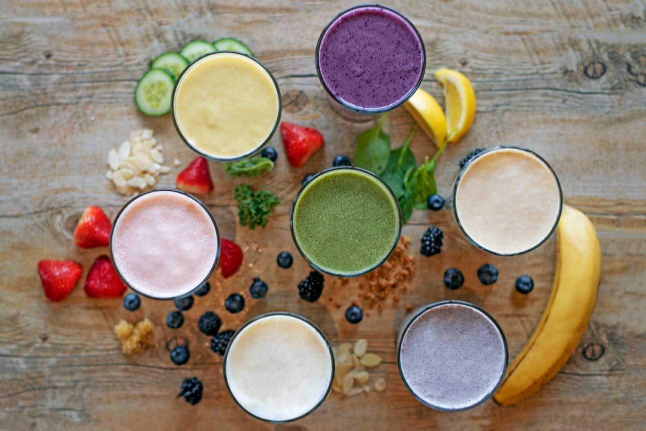 Assorted fruit smoothies with fresh fruit